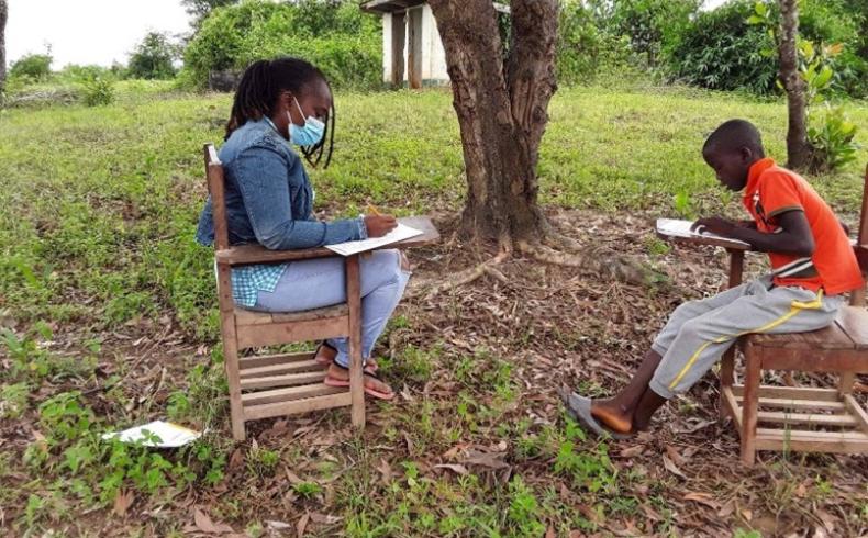Coach , Susan P. Nagbe conducting period four ORF  at the Jarpata Public School with one of the grade two  student , David ..jpg