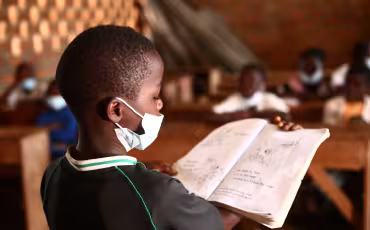 A grade 1 student reading before his class (1).JPG