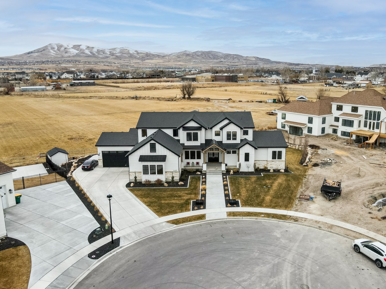 39963 Welcome to Lehi Luxury at its finest!!! Don't miss this spectacular 8,119 Sq. foot, totally custom-built, smart home, located in a cul-de-sac in one of Lehi's premier subdivisions, Indian Springs! The upgrades in this home will blow you away! From the water fountain in your mudroom and the giant lockers, epoxy floors in the garage, to the shiplap in the ceilings and the endless can lights, the butler's pantry that is hidden behind a secret cabinet door, equipped with a dishwasher, sink, plenty of counter space, and floor to ceilings storage. You want pebble ice? This house has that too! You'll be amazed at the Giant 10 x10 oversized quartz island in the kitchen perfect for large gatherings. Tired of waiting for the water in the shower to get up to temp? Not in this master bath. Voice command turns on the shower to your pre-set desired temp with each shower head, gold fixtures throughout the home, blinds for the floor-to-ceiling windows are controlled by remote, washer/dryer hookups in the master closet, Jack-n-jill bathroom connects 2 of the bedrooms on the 2nd floor, walk in closets in all bedrooms, spacious theater room, home gym, shiplap galore, in ground trampoline, you'll admire the excellent cabinetry and finish work. Entertain on the big beautiful covered deck, around the firepit, or in the well appointed, fully finished basement complete with a stunning kitchen. Beautifully landscaped, on a huge half acre lot! Open land behind the home said not to be developed for many years to come. Potential for mother in law apartment in the basement! Square footage figures are provided as a courtesy estimate only and were obtained from the building plans . Buyer is advised to obtain an independent measurement.