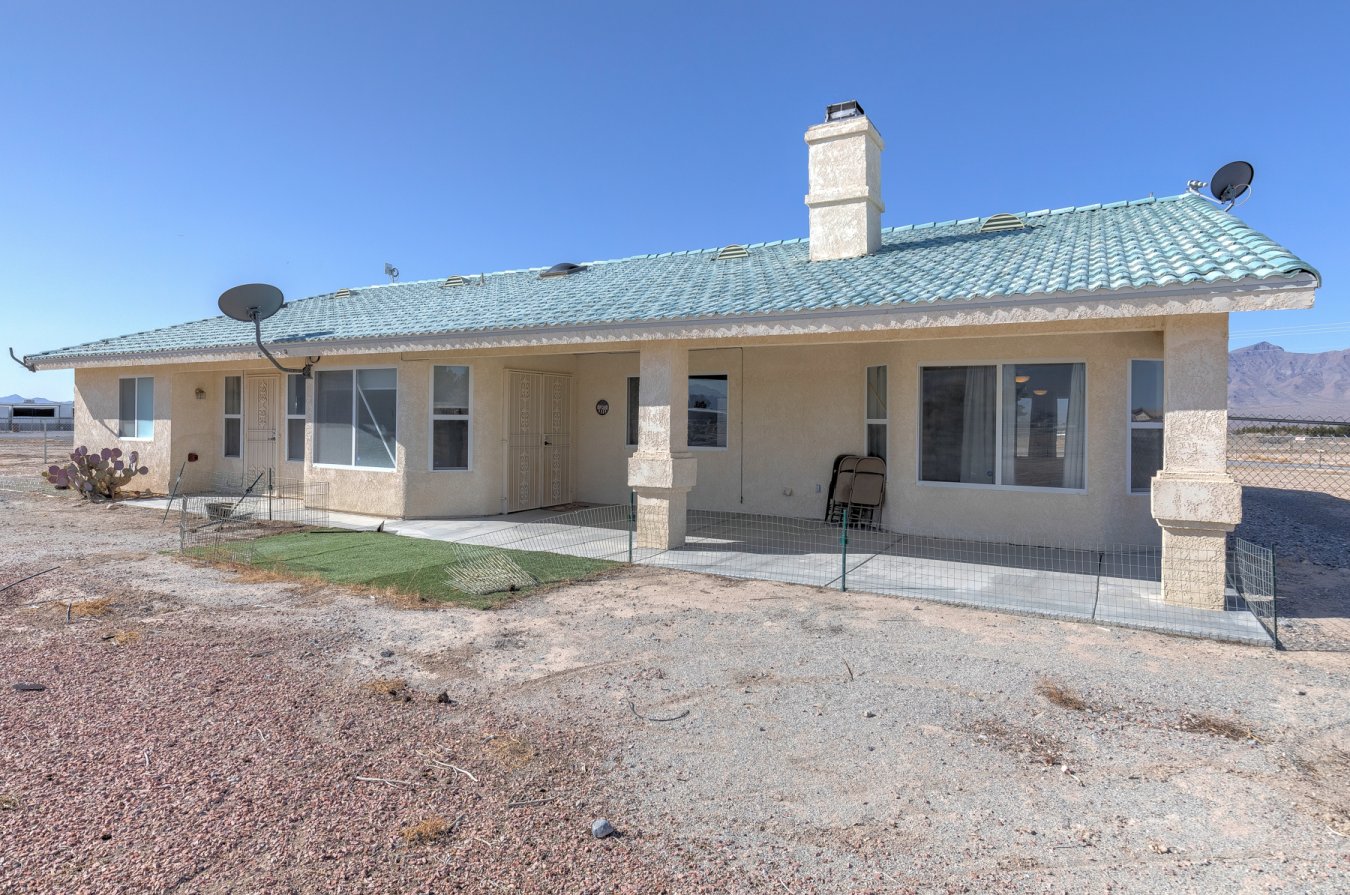 Plenty of room here for horses & all your toys! 3 bedroom move-in ready home on 2.4 acres with spectacular mountain views PLUS a separate 60x40 shop! Home has been freshly painted throughout the interior * New laminate flooring * Brand new carpet in master bedroom * Spacious living room features 2 skylights, vaulted ceiling & wood burning fireplace * In the kitchen you will find a built-in cooktop, oven & microwave along with a stainless steel refrigerator that stays with the home - there is also a walk-in pantry, breakfast bar & generous eat-in dinette area * Formal dining room with vaulted ceiling * Master bedroom is separate from others & has walk-in closet & master bath featuring large soaking tub & walk-in shower * Washer & dryer stay * You will love all the great features in the 2400 sq. ft. shop - 400 amp service with 3 phase electrical, 2 swamp coolers, a separately ventilated office plus a bathroom * All this PLUS a 4 post car lift/loading platform right outside of shop *