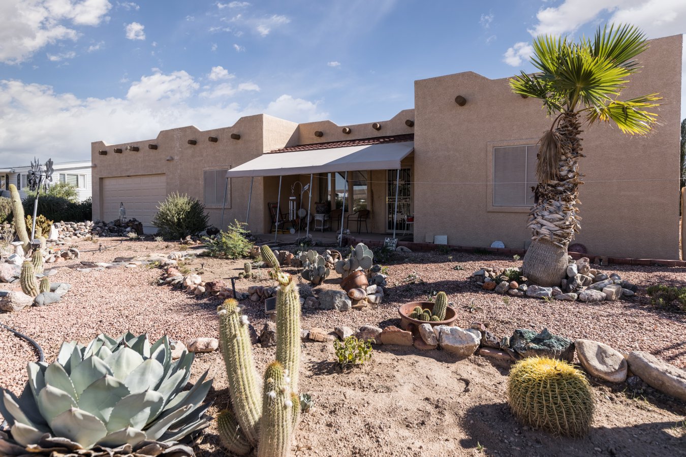 This is a very special house with lots of pride of ownership. House was constructed in 2005 using panel construction. Southwestern flat top roof design. When you enter the home, you can just feel the warmth from the earth tone colors. There are three bedrooms with the master split off to the south side of the home. Master is large with 9ft ceiling, walk-in closet, master bath with shower. On the other side of the home are two bedrooms divided by the second bathroom. An Arizona Sunroom provides perfect light for morning coffee or a place to do crafts. This home has a detached two car garage and an outside patio area with beehive fireplace. This area has been enclosed and connects to another large garage/ workshop. Front, back and side yards have numerous plants, trees, and shrubs. From the outdoor patio you have views of the mountains. Come and enjoy all that this of northwest Arizona has to offer. Mesquite, Nv 9 miles, St. George, UT 25 miles, Las Vegas, NV 90 miles.