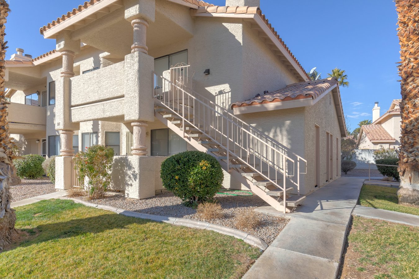54789 Fantastic find and fully furnished!!! Enjoy the comfort and tranquility of this two-bedroom, two-bath home on the outskirts of Summerlin. The home overlooks the gated pool and greenbelt area and is located at the end of a cul-de-sac.
Covered parking is just a few feet from your front door. Boat/RV parking is also available. There is tile flooring in the high traffic areas and deep champagne-toned carpeting in the other rooms. All of the kitchen appliances, as well as the full-sized washer and dryer, stay with the property. Breakfast bar w/granite countertops. Bedrooms have mirrored closet doors. The home is located close to the 110 acre Kellog Zaher Sports Complex. It is a few blocks to Lowe's Home Improvement, Trader Joe's, Winco, and highway access. It is a short drive to Boca Park and a profusion of restaurants, casinos, and shops. The owners have gently used this as their get-away home over the last 23 years. All furniture will convey with the property.