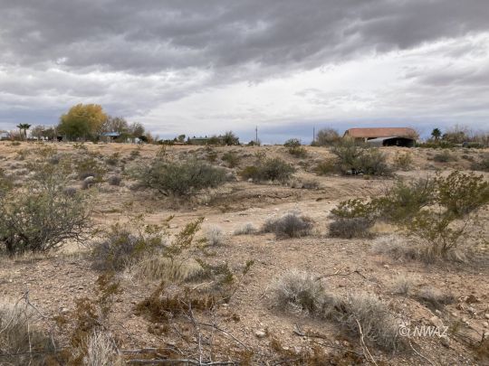 55650 Incredible mountain views from this location. This lot can be so many things. Build a dream home or just enjoy it for the winter. The back door lot can also be purchased and make this an amazing spot. Centrally located in Scenic Arizona a hidden spot from so many. Neighboring states are Nevada and Utah. Both have so much to offer from golf courses to national parks in addition to riding trails and so much more.