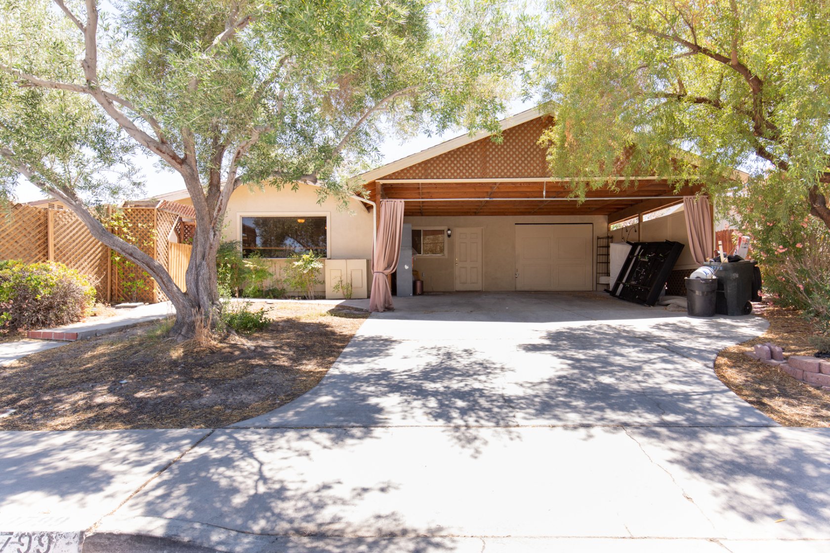 Spacious move-in ready home featuring in-law quarters with a separate entrance, kitchenette, bedroom with a fireplace, its own private bath, walk-in closet & a door to the backyard! This single story home also has 2 other generous sized bedrooms, one of which also features a door to the private backyard. Large living room is just next to the kitchen and offers plenty of space to relax. You'll love the spacious dining room just off the kitchen as well. Beautiful courtyard by the front door offers the perfect space to enjoy your coffee in the morning. The serene, private backyard offers another spacious retreat for relaxing featuring a patio and artificial grass.