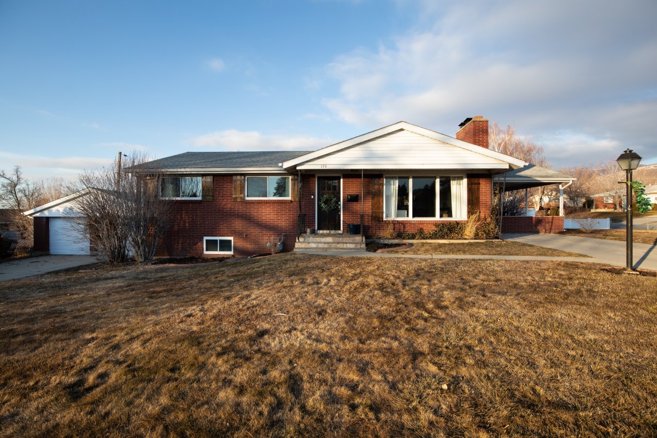 Beautifully updated 4 bedroom, 3 bathroom all brick rambler home. Master bedroom has an ensuite bathroom. Huge open family room in the basement with a second cute vintage kitchen. Main floor kitchen has granite countertops with a farmhouse sink and includes the refrigerator. Large covered patio surrounded by raised up planters for privacy. Great location, just minutes to I-15.