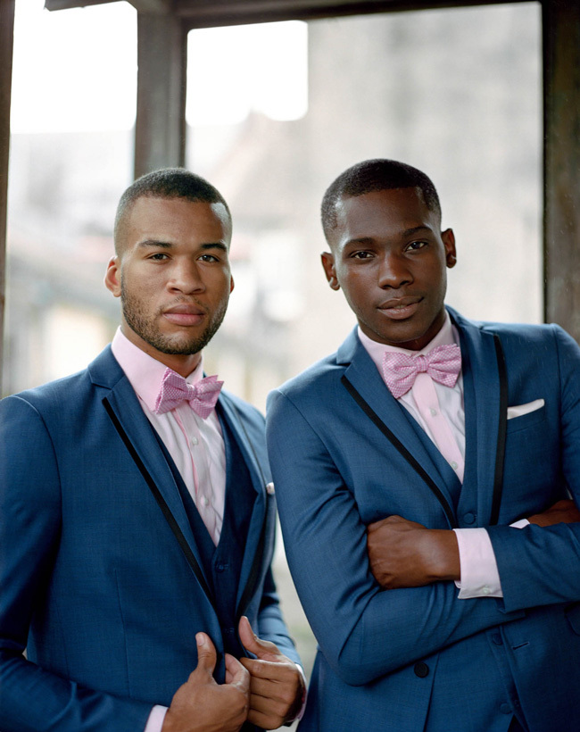 Stylish groomsmen in blue suits with pink bow ties Stylish groomsmen in blue suits with pink bow ties