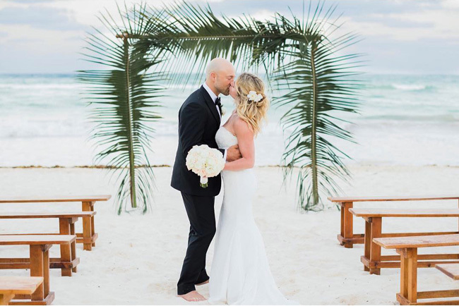 Palm leaves frame beach wedding ceremony Palm leaves frame beach wedding ceremony