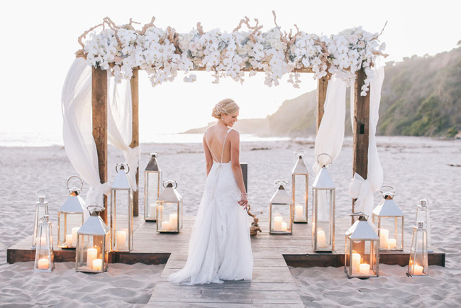 White florals on a wooden beach wedding chuppah White florals on a wooden beach wedding chuppah