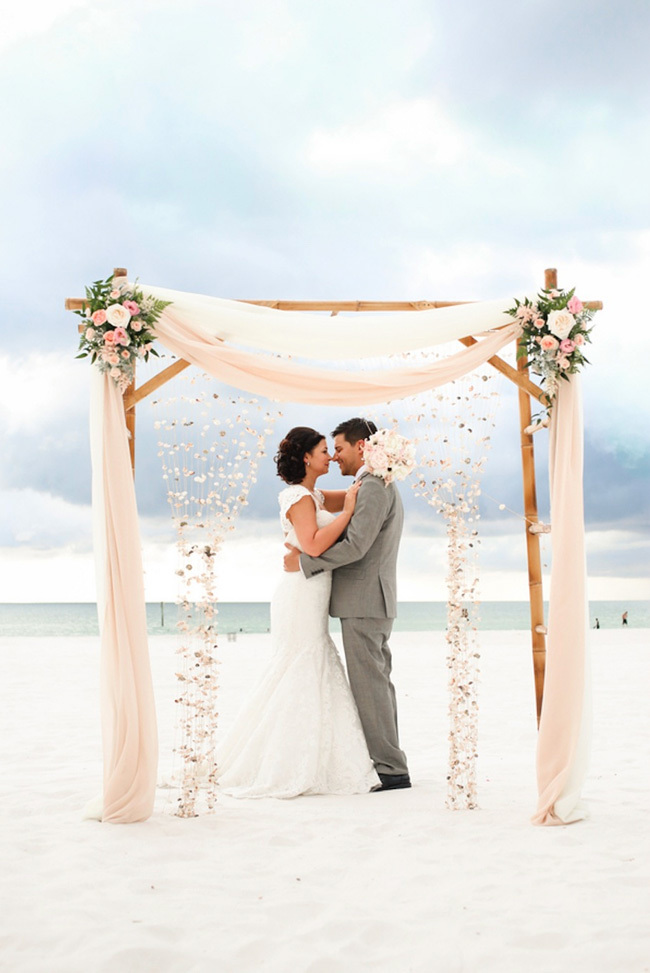 Beach wedding chuppah draped in pink fabric Beach wedding chuppah draped in pink fabric