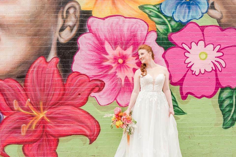 Colorful Wedding Ideas that aren't flowers | Bride standing in front of a colorful mural
