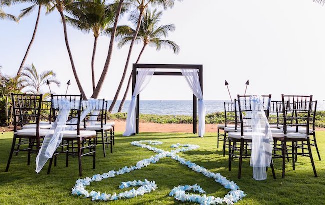 A destination wedding ceremony arch on a beach