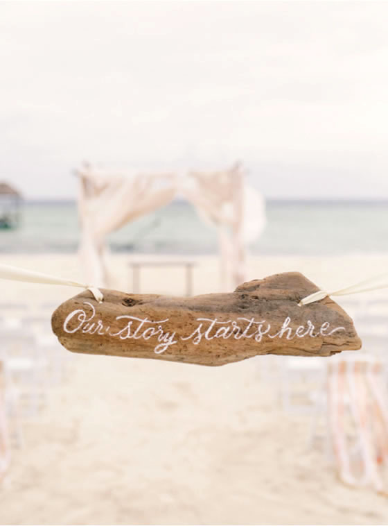 Beach wedding décor idea: Driftwood sign Driftwood ceremony sign that says Our Story Starts Here