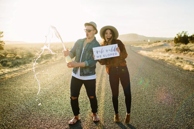 Casual and Cool Elopement Announcement Hip couple that just eloped pop a bottle of champagne on the street