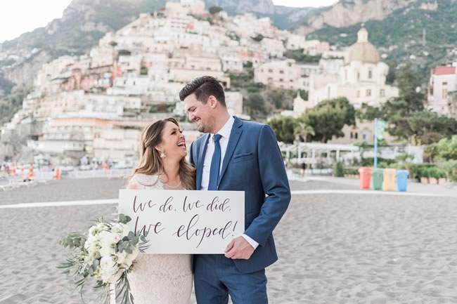 Creative Way To Announce Your Destination Elopement Newlyweds hold up elopement announcement in Positano Italy