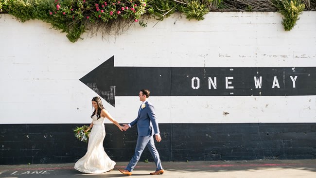 What To Consider Before You Elope Bride and groom crossing the street hand-in-hand