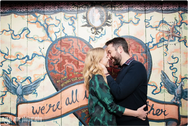 Engagement photos in front of a colorful mural Engagement photos in front of a colorful mural