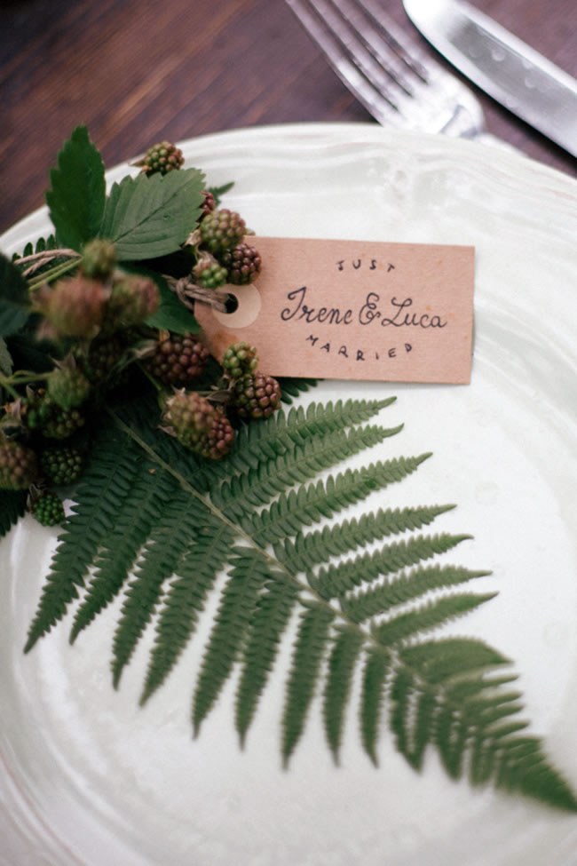 Forest Wedding Place Setting Simple white place setting with a fern leaf and berries