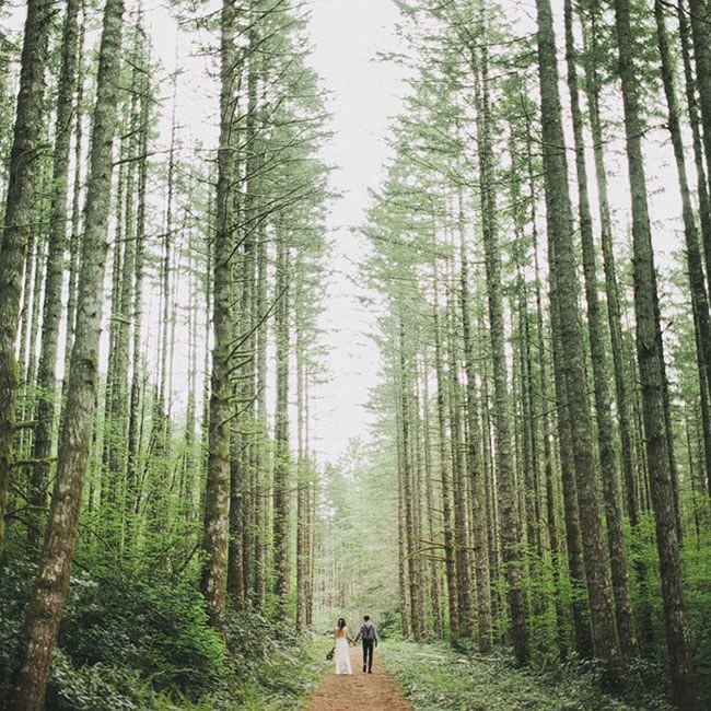 Forest Wedding Photo Idea by Ben Haisch A wedding couple walking through a forest of towering trees