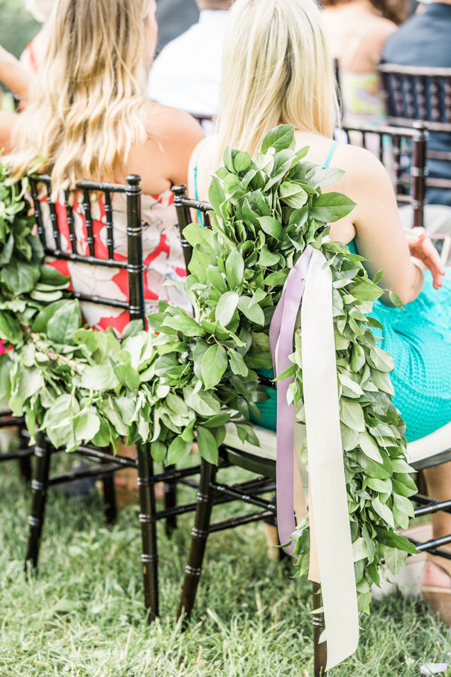Lemon Leaf and Ruscus greenery garland on garden wedding ceremony chairs Lemon Leaf and Ruscus greenery garland on garden wedding ceremony chairs