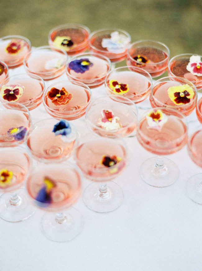 Wedding signature cocktails with floating edible flowers Wedding signature cocktails with floating edible flowers