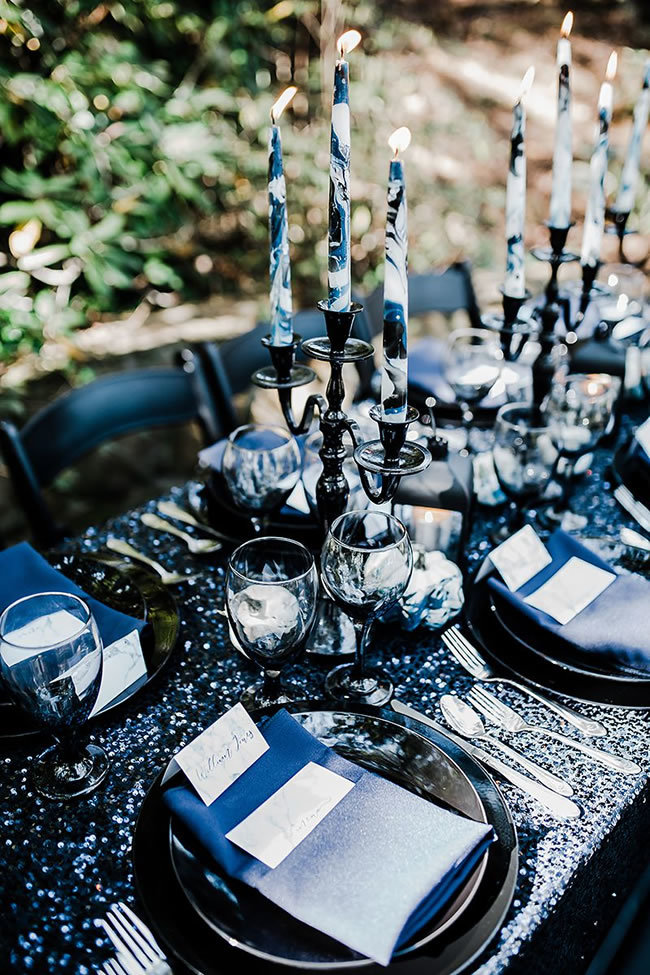 Moody black wedding tablescape with candelabras Moody black wedding tablescape with candelabras