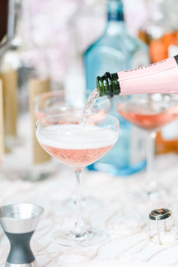 Pink wedding champagne poured from the bottle