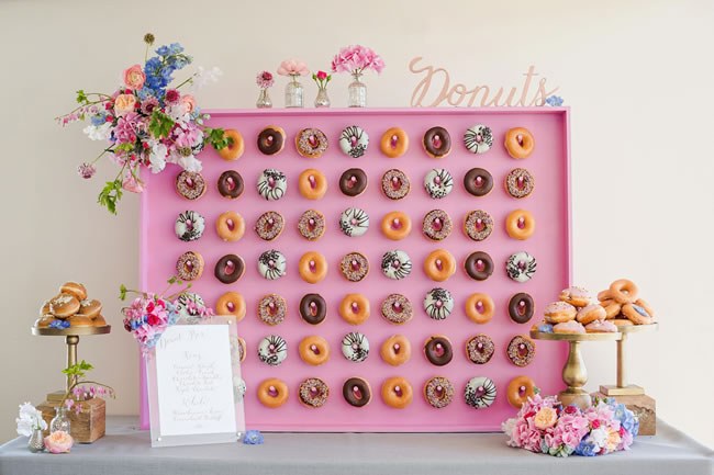 A pink wall of wedding donuts