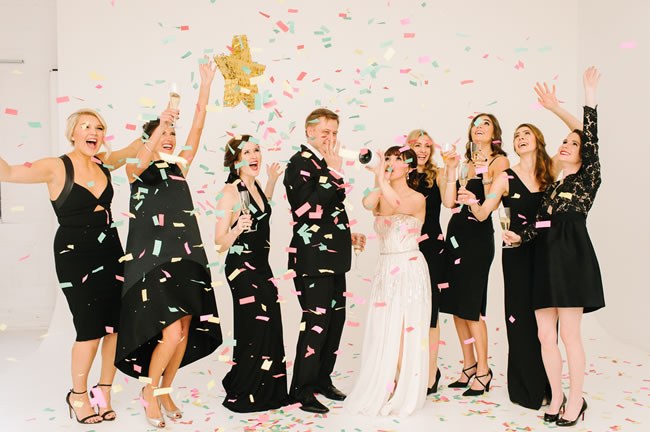 Wedding guests partying with champagne and confetti