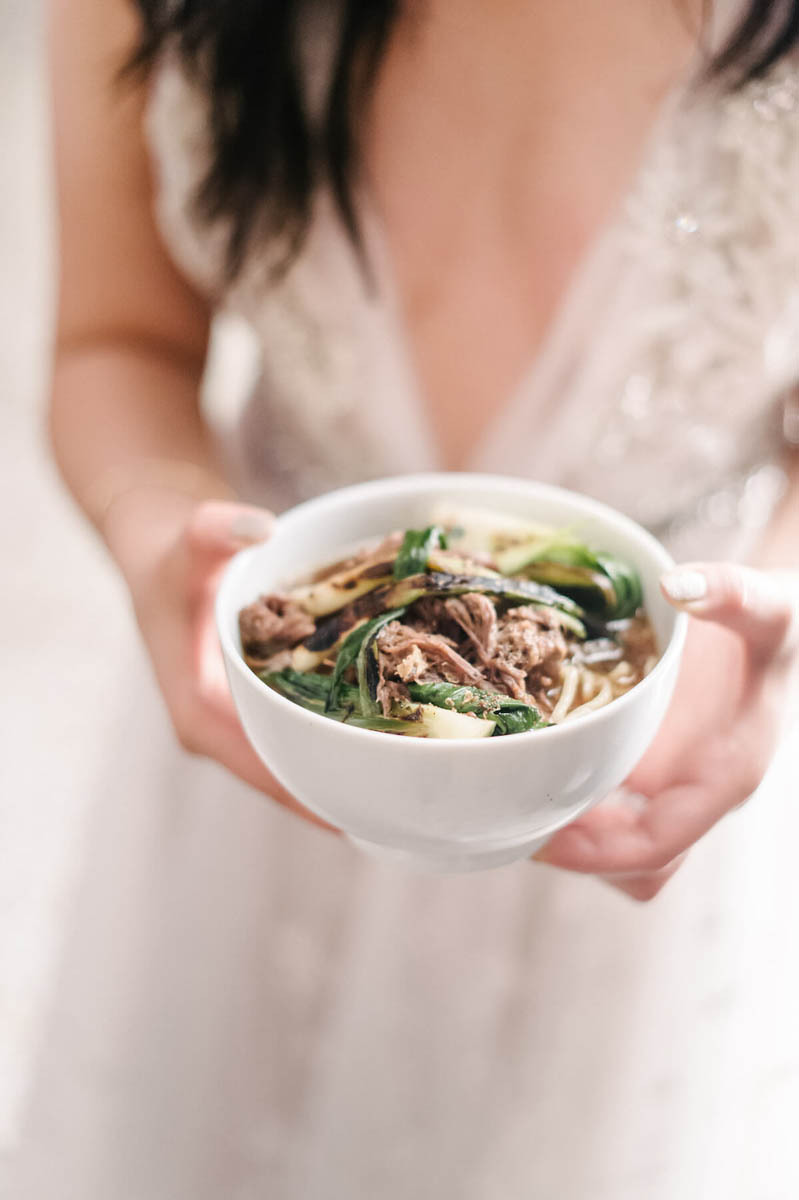 A bride holding a bowl of soup