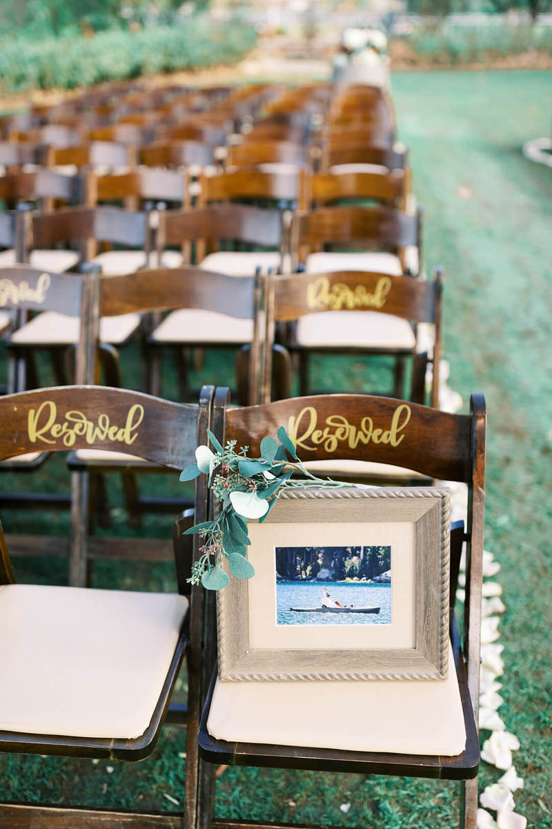 A memorial frame placed on a reserved seat at a wedding ceremony