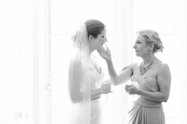 Mother of the bride touches her daughter's face | How to include mom in wedding