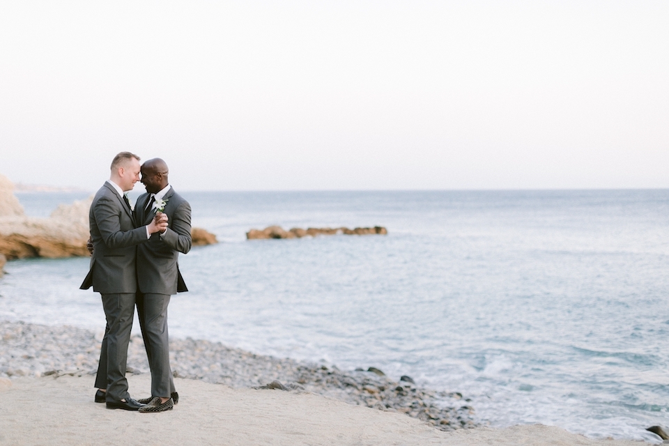 Two grooms dance on the shores of Terranea Resort | Tips for making your wedding more inclusive