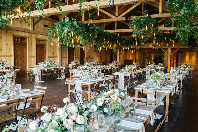 A rustic indoor wedding reception at Devil's Thumb Ranch Resort and Spa in Colorado keeps guests sheltered from the elements.