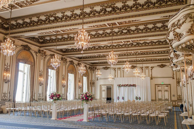 The Gold Room at Fairmont San Francisco with elaborately ornamented vaulted ceilings, gold leaf detailing, and crystal chandeliers.