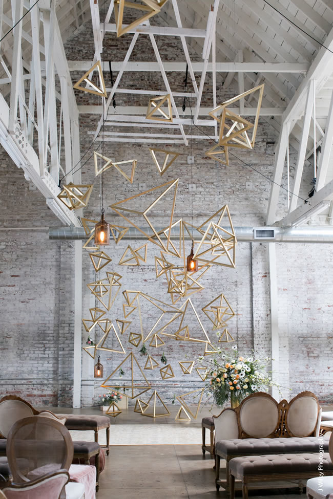 Hanging installation of geometric shapes at an industrial-chic wedding Hanging installation of geometric shapes at an industrial-chic wedding