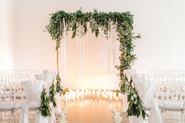 Industrial-wedding ceremony arch covered in greenery Industrial-wedding ceremony arch covered in greenery
