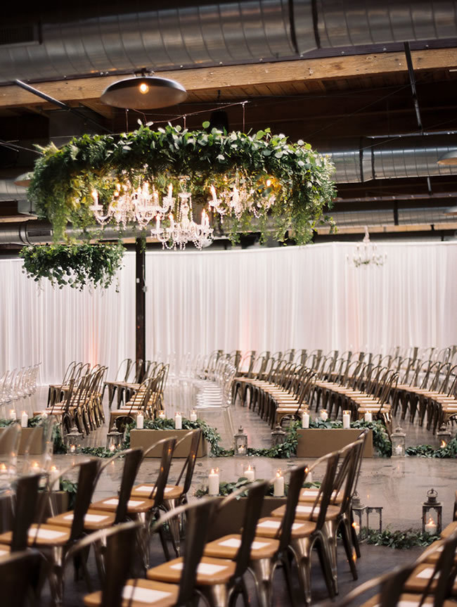 Industrial-chic wedding ceremony with metal chairs and white draping Industrial-chic wedding ceremony with metal chairs and white draping