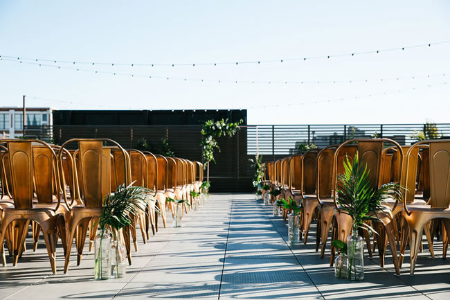 A rooftop wedding ceremony with copper chairs at The Pearl SF A rooftop wedding ceremony with copper chairs at The Pearl SF