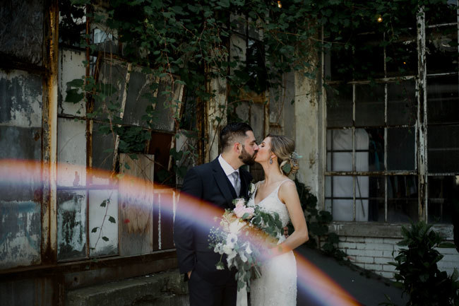 Rainbow appears as newlyweds kiss at their industrial-chic wedding Rainbow appears as newlyweds kiss at their industrial-chic wedding