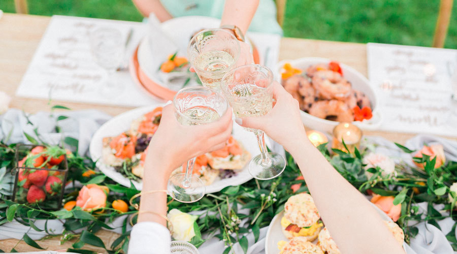 Champagne toast across a beautifully catered table by Colette's Catering & Events