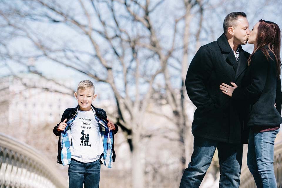 Involve kids in your marriage proposal | A young boy wears a Mommy please say yes shirt to help dad propose