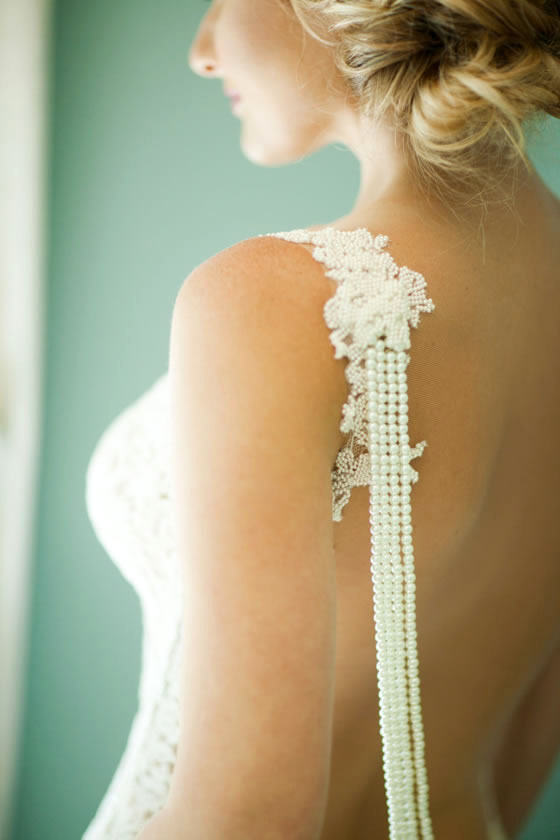Beach wedding décor idea: Pearls Wedding dress with pearl strands hanging down the back