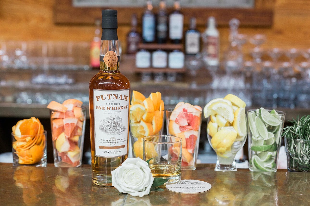A bottle of whiskey and selection of colorful garnishes | Wedding Bar Packages