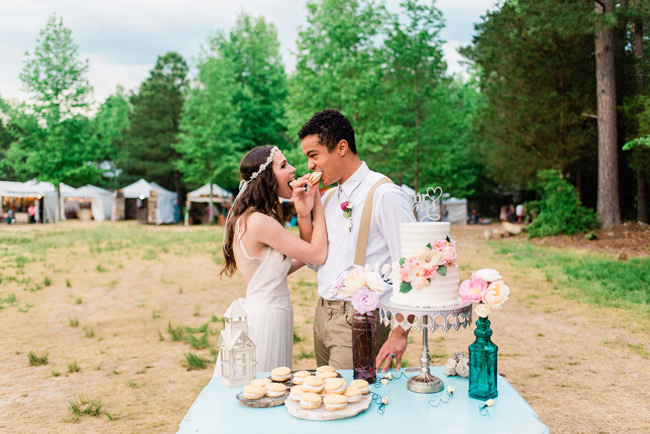 Wedding Food Bar Ideas | Newlyweds feeding each other cookies from their wedding dessert table