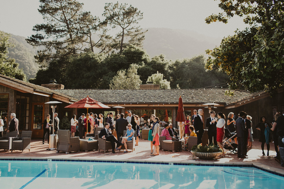 Wedding guests enjoy time by the pool at Gardener Ranch
