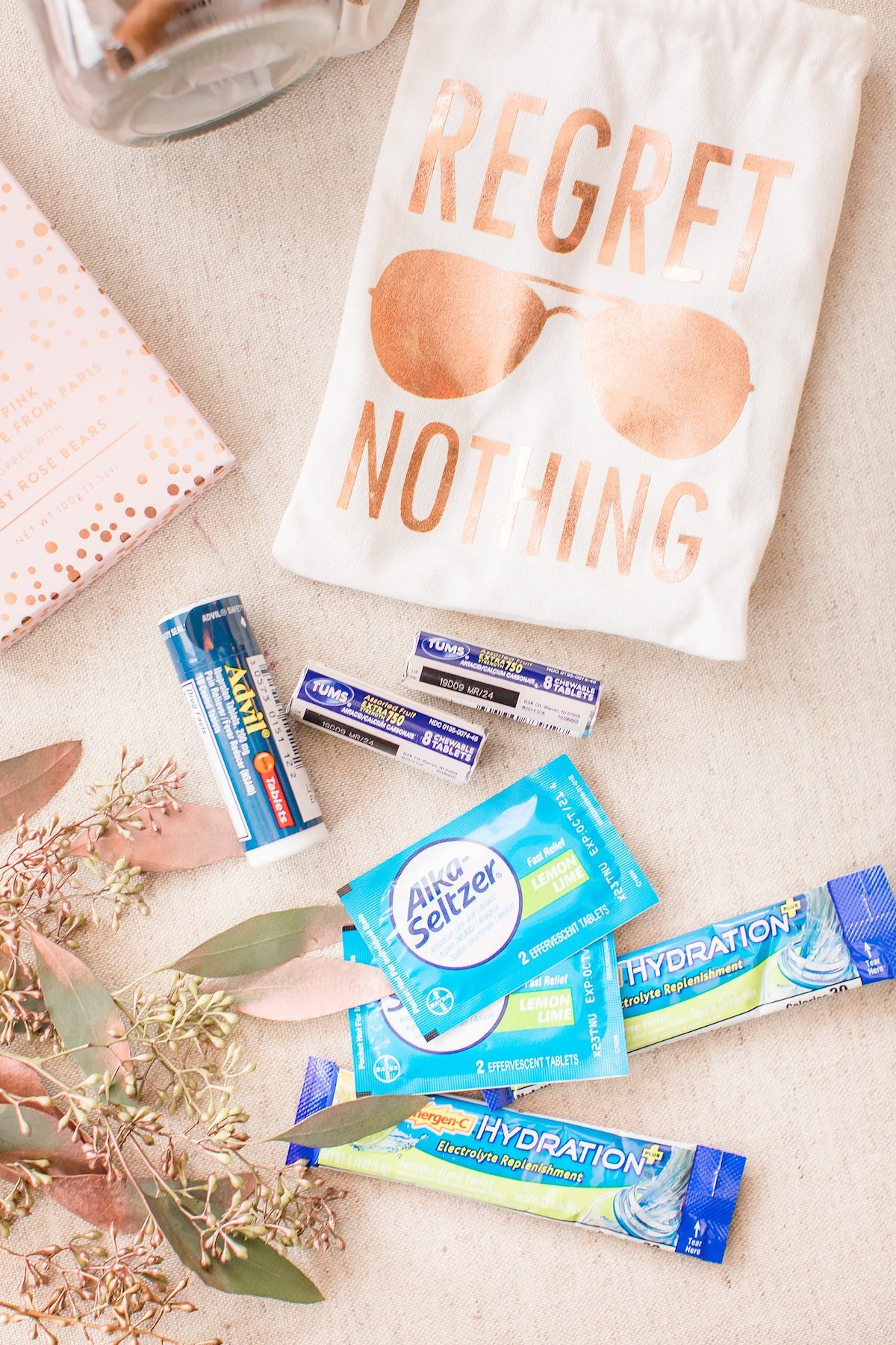 A wedding hangover kit in a Regret Nothing bag with Advil and Alka-Seltzer