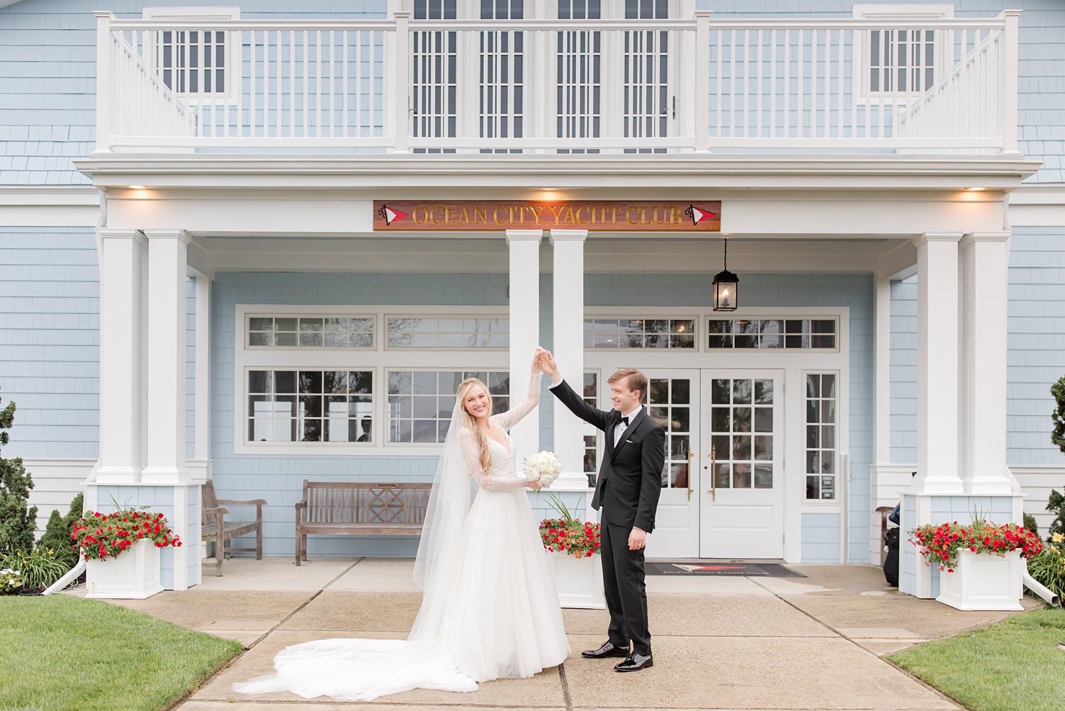 Bride and groom twirling outside the Ocean City Yacht Club on their wedding day
