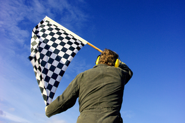 man waiving race flag