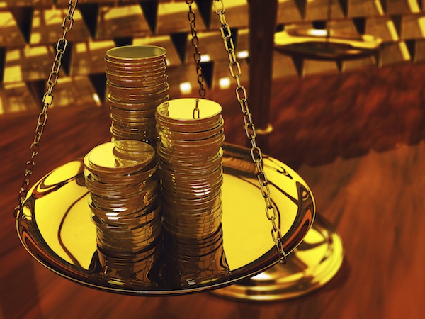 gold coins on scale