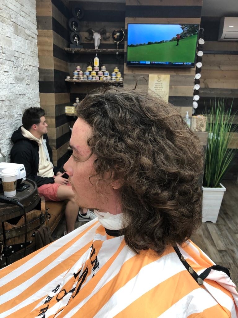 How often should one get a touch-up or trim for a mid taper fade with pomp hairstyle?